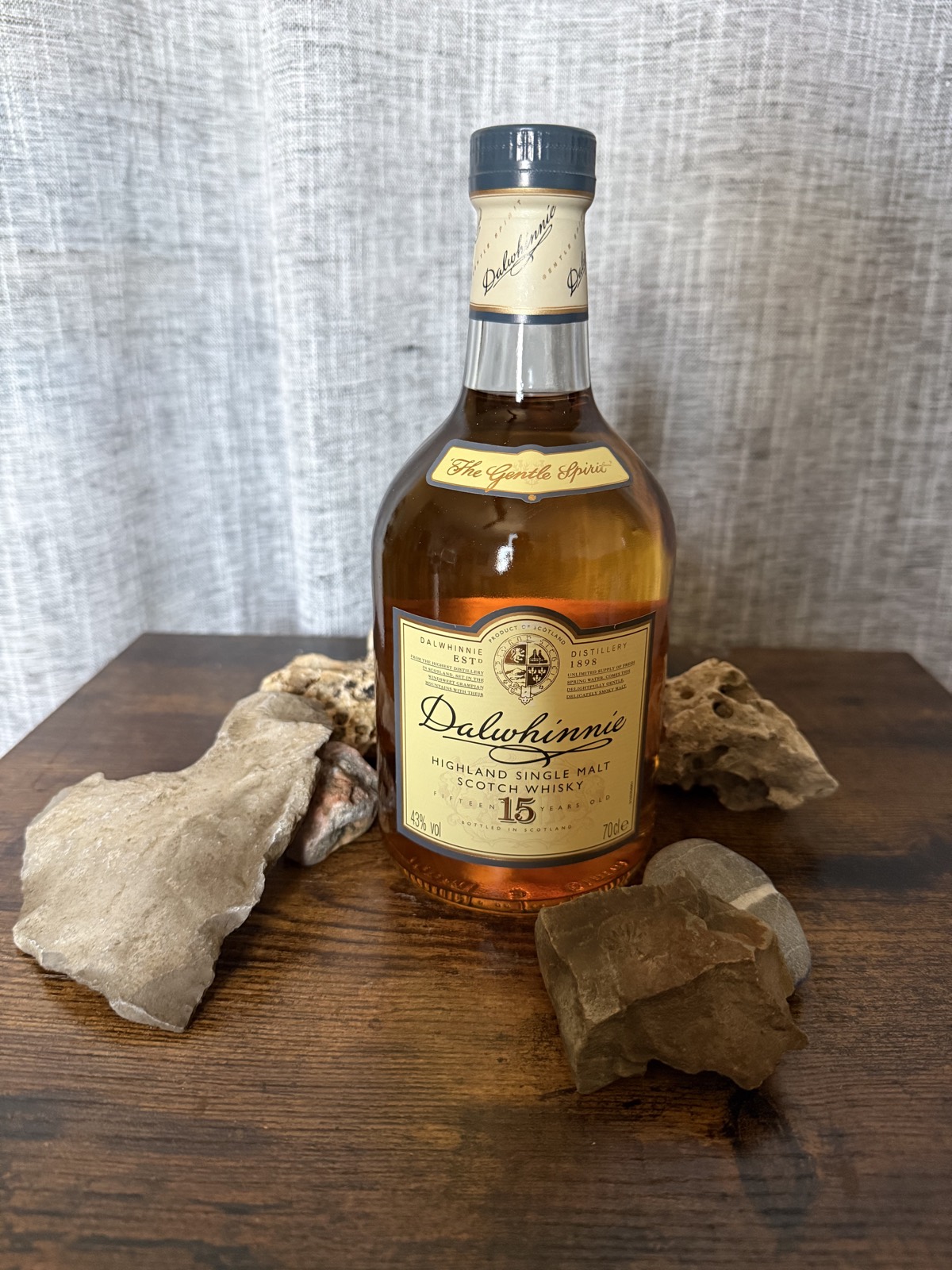 Dalwhinnie 15 Year Old bottle among Highland stones